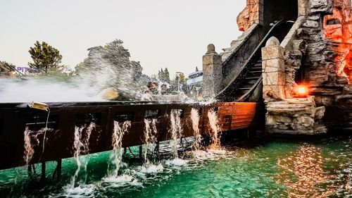 View of fountain in canal against building