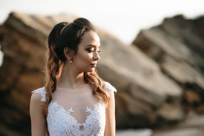 Close-up of young woman looking away outdoors