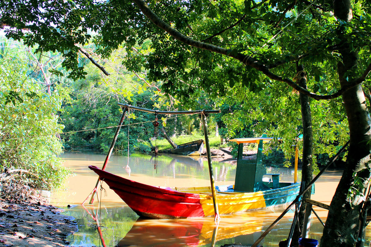 BOATS MOORED ON LAKE