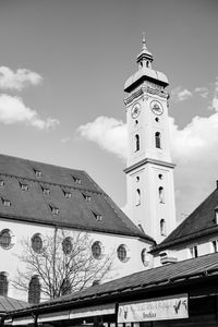 Low angle view of clock tower against cloudy sky