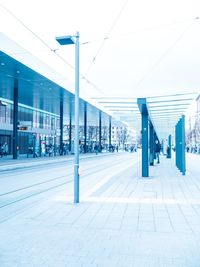 Footpath amidst buildings in city against clear sky