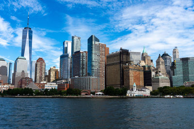 Buildings in city against cloudy sky