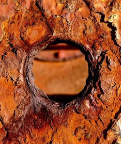 Full frame shot of rusty metal with circle shaped hole