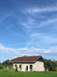 House on field against sky