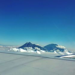 Scenic view of snow covered mountains against clear sky