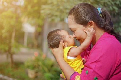 Side view of mother playing with son