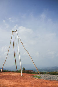 Wind turbines on field against sky