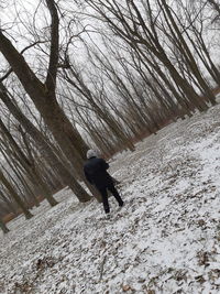 Man walking on snow covered land