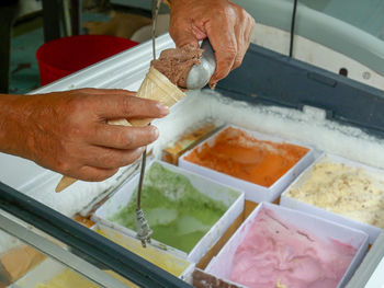 Midsection of man preparing food in kitchen