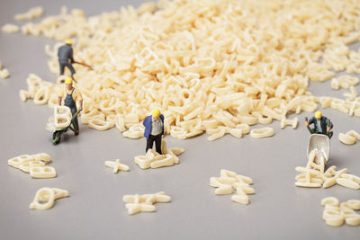 Figurines and alphabet noodles on table