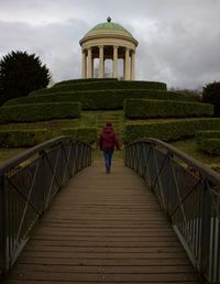 Rear view of woman standing on steps
