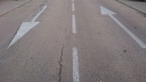 High angle view of arrow symbols on road