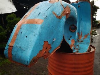 Close-up of rusty machine part on field