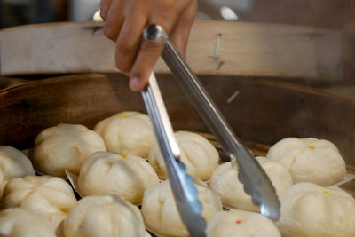 Cropped hand of man preparing food