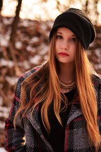 Portrait of young woman standing on field