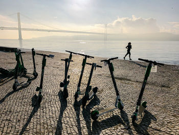 People standing on beach by sea against sky