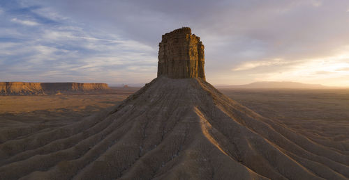 Erosion cuts deep lines in the earth surround the chimney rock m