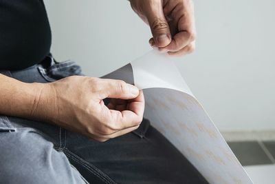 Midsection of person holding paper