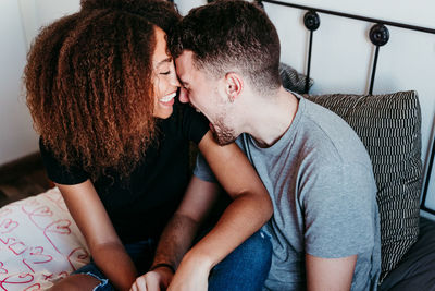 Midsection of couple sitting at home