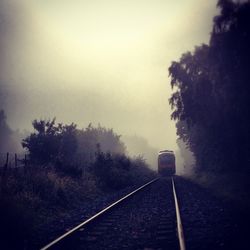 Railroad track passing through foggy weather