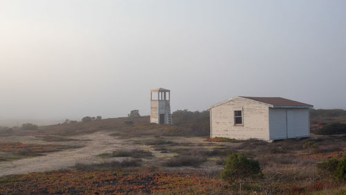 Buildings on field against sky