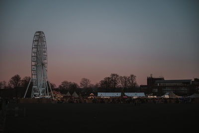 Illuminated buildings against sky at night