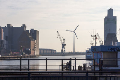 Commercial dock by river against sky in city