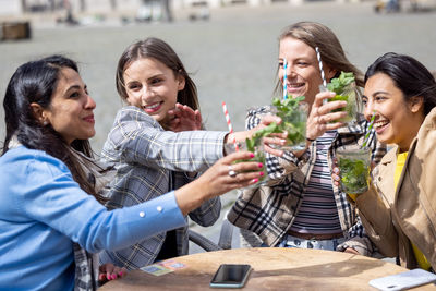 Friends toasting drinks at restaurant