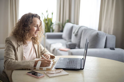 Businesswoman using laptop while sitting at home