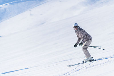 Portrait of woman skiing on snowcapped mountain