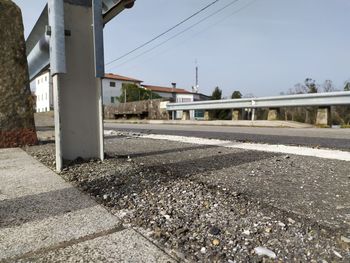 Surface level of railroad tracks in city against sky