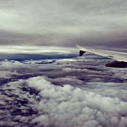 Cropped image of airplane flying over landscape