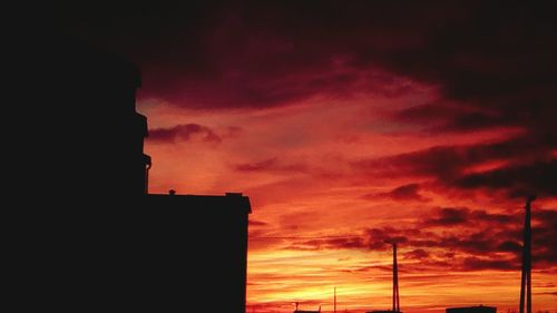 Silhouette built structure against sky during sunset