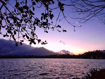 Scenic view of lake against sky at sunset