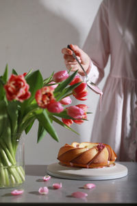 Midsection of woman holding bouquet