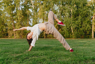 Full length of man skateboarding on field