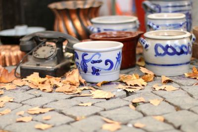 Close-up of earthenware pots on street during autumn 