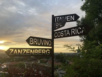 Low angle view of road sign against sky