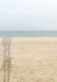 Scenic view of beach against clear sky