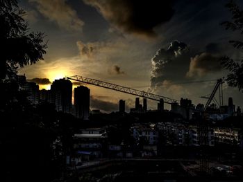 View of cityscape against cloudy sky