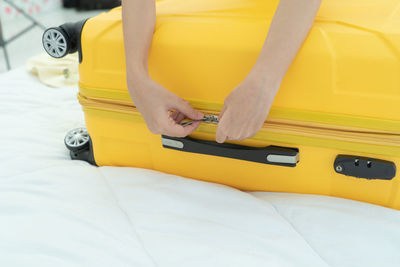 Midsection of woman lying on bed