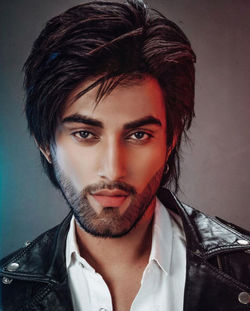 Close-up portrait of young man against wall