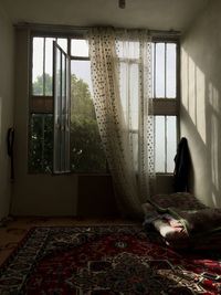 Man looking through window at home