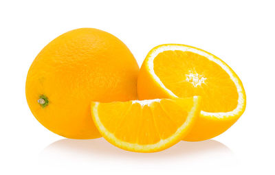 Close-up of orange fruits against white background