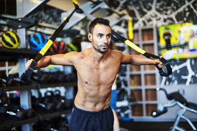 A fit man working out at the gym.