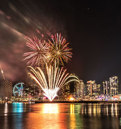 Firework display over city at night