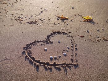 High angle view of a heart drawn on sand