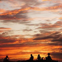 Silhouette of people at sunset