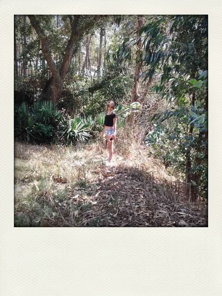 lifestyles, full length, tree, leisure activity, transfer print, casual clothing, rear view, standing, auto post production filter, growth, grass, walking, forest, childhood, nature, green color, tranquility, field