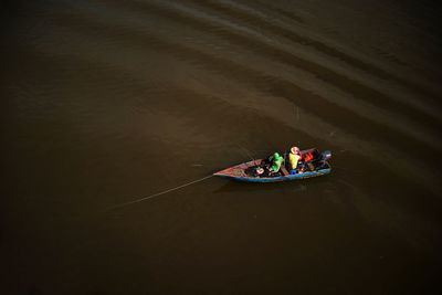 High angle view of fishermen fishing on boat in sea